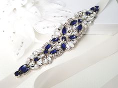 a blue and white bridal bracelet sitting on top of a table