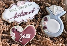 two decorated cookies in a box with the words will you be my bridesmaid?