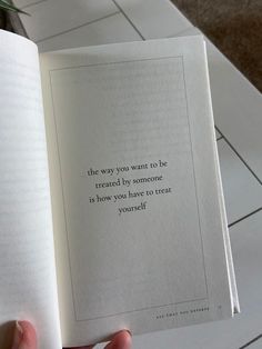 a person holding an open book with a quote on it