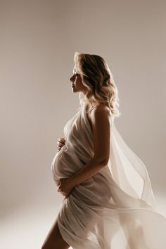 a pregnant woman in a white dress