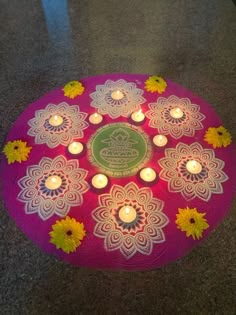 a pink mat with lit candles on it