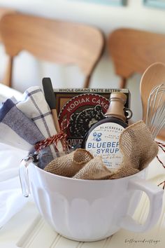 a white bowl filled with kitchen items on top of a table