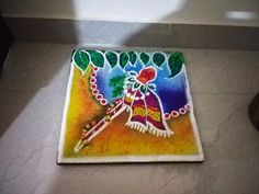 an artistic painting on the floor in a room with white walls and tile floors,