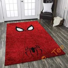 a red rug with a spiderman face on it in front of a white door