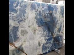 a large blue and white marble slab in front of a building