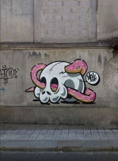 graffiti on the side of a building with a skull and donut painted on it