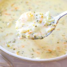 a spoon full of broccoli cheese soup