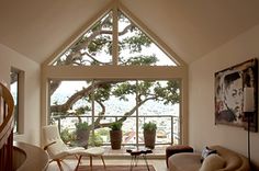 a living room filled with furniture and a large window