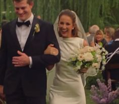 a bride and groom walking down the aisle