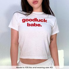 "Chappell Roan Baby Tee Good Luck Babe LGBTQ WLW Bisexual Pansexual" Graphic Slogan Printed On Aesthetic Retro Vintage 90s Y2k Baby Tee Shirt with our own unique font.  🎨 Available in White, Light Pink, Light Blue, Navy, Black. If you need a different color, please let us know! (Ash, Red, Sport Grey & Green)  🎁 Our baby tees are perfect gift for her or him offering timeless fashion and versatility that anyone will cherish. Baby tees, popular in the '90s, have short sleeves and a slightly cropp White Cropped T-shirt With Slogan For Streetwear, Cute White Cotton Cropped T-shirt, Band Merch Cropped T-shirt With Letter Print, White Cotton Cropped T-shirt With Screen Print, Funny White Slogan Tops, White Y2k Cropped T-shirt With Letter Print, Funny Slogan White Tops, White Cropped Crew Neck T-shirt With Letter Print, White Cropped T-shirt With Letter Print, Crew Neck