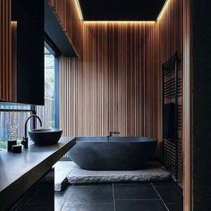 a bath room with a large tub and a sink