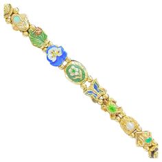 pre owned but in excellent condition retro vintage slide bracelet 14k yellow gold total 35 grams 12 slides total length 7' inches circa 1940 slides include am emerald and topaz stone and serval enamel pieces. every slide is stamped 14k extra security chain lock + Appraisal and Gift Box (#19280091 bij) Retro Bracelet, Chain Lock, Slide Bracelet, Topaz Stone, Animal Jewelry, Topaz, Slides, Retro Vintage, Jewelry Bracelets