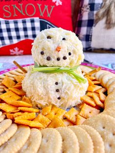 a snowman made out of rice krispy kreme balls on top of crackers