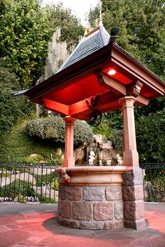 a small gazebo in the middle of a park