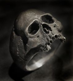 "Custom made to order Almost Toothless Sterling Silver Skull Ring - Solid .925 Weighs 32 grams ( 1 ounce) of sterling silver - .925 (size 11) Vintage and distressed - unbelievably realistic! Old Bone - vintage finish with loads of painstaking detail and character made to look like a found ancient artifact. Hand carved in wax by me in my studio then cast in solid sterling silver (.925) The inside is mirror polished for comfort. Height is 25mm (1 inch) from top of skull to bottom of teeth. Width i Rocker Rings, Pirate Ring, Vampire Skull, Goth Ring, Sterling Silver Skull Rings, Mens Skull Rings, Wallet Chains, Bone Ring, Skull Rings