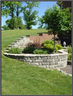 a stone wall in the middle of a yard