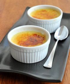 two bowls of soup on a black plate