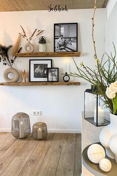 the shelves are filled with pictures and vases on top of each other in this room