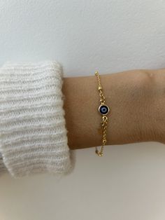 Brush away negative energy and stay protected with this dainty evil eye bracelet! D E T A I L S *It features a gold filled evil eye charm (12 x 6.5mm) in traditional blue *on a high quality 18k gold filled chain in yellow gold. *Gold filled is a wonderful alternative to solid gold and unlike gold plating does not rub off. *A tiny gold filled cross dangles from the chain. *It closes with a hall marked gold filled spring clasp measuring 6mm. *Choose the length from the drop down menu. Use the length guide as a reference to help you get the right size. If unsure you can ask for an extender to be added. C A R E * T I P :  To keep your bracelet in great condition avoid contact with water, perfume and chemicals. Also remove when exercising and sleeping . P A C K A G I N G: All our products are g Elegant Everyday Evil Eye Bracelet, Dainty Adjustable Gold Evil Eye Bracelet, Gold Spiritual Evil Eye Bracelet With Adjustable Chain, Dainty Gold Adjustable Evil Eye Bracelet, Dainty Gold Evil Eye Bracelet, Adjustable, Dainty Evil Eye Bracelet With Adjustable Chain, Dainty Evil Eye Bracelet For Everyday, Everyday Yellow Gold Evil Eye Bracelets, Minimalist Evil Eye Bracelet With Adjustable Chain As Gift