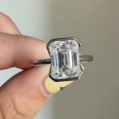 3 CT Emerald Cut Moissanite Engagement Ring Emerald Cut Bezel Setting Solitaire Ring Emerald Cut Diamond Wedding Ring Anniversary Ring ⦿ 𝐃𝐞𝐬𝐢𝐠𝐧 𝐍𝐨 : JPR137EME 18 ⦿ 𝐑𝐢𝐧𝐠 𝐃𝐞𝐭𝐚𝐢𝐥𝐬 * Main Stone Shape : Emerald Cut * Main Stone Carat Weight : 3 carat Approx. * Main Stone MM Size : 10X8MM * Stone Type: Moissanite Diamond  * Stone Color: D Color * Stone Clarity: VVS1 * Custom color: Solid Rose Gold, Solid Yellow Gold, and Solid White Gold. * All silver or gold pieces are stamped with Moissanite Engagement Ring Emerald Cut, Moissanite Engagement Ring Emerald, Bezel Set Wedding Ring, Engagement Ring Emerald Cut, Emerald Cut Moissanite Engagement Ring, Engagement Ring Emerald, Ring Emerald Cut, Emerald Cut Moissanite, Emerald Engagement Ring Cut