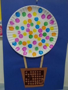 a paper plate with colorful dots on it and a keyboard attached to the back of it