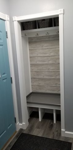 an empty white closet with shelves and baskets