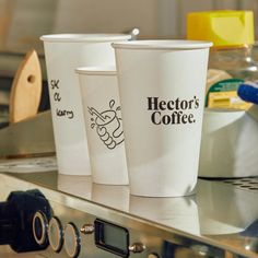 three coffee cups sitting on top of a counter