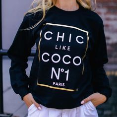 The chicest sweatshirt you'll ever own!Product Details Unisex, Classic Fit, Crew Neck Cotton-Poly Blend Sweatshirt Available Colors: Black with Gold & White Graphic Chanel Sweatshirt, Chic Sweatshirt, Lucky Brand Sweater, Cute Shirt Designs, Black Knit Sweater, Detailed Sweater, Workout Sweatshirt, Cozy Sweatshirts, Cute Shirts