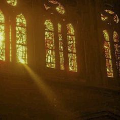 the sun is shining through stained glass windows