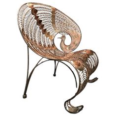 a metal bench with an intricate design on it's back and arms, sitting in front of a white background