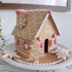 a gingerbread house decorated with icing on a plate