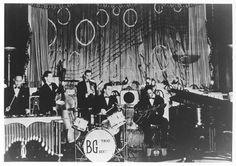 an old black and white photo of some people on stage with musical instruments in front of them