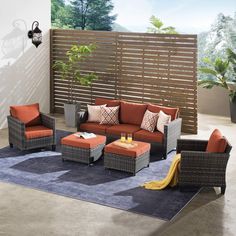 an outdoor living room with orange and brown furniture