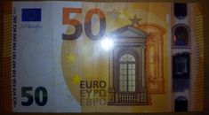 a 50 euro bill with the image of a building on it's front side