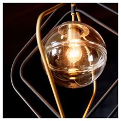 a light that is sitting on top of a metal stand with a glass ball hanging from it's side