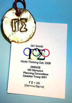 an olympic medal hanging from a card on a blue background with the text rio olympics