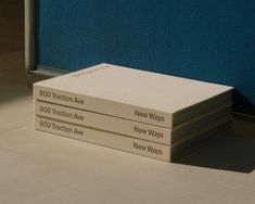 three books stacked on top of each other in front of a blue wall