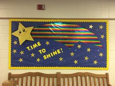 a bulletin board that says time to shine with a rocket ship and stars on it