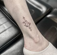 a person with a tattoo on their foot and the word love is written in cursive letters