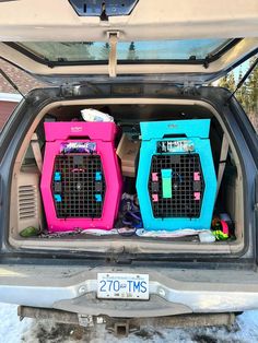 the back end of a car with two large cages in it's cargo compartment