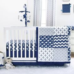 a baby crib with blue and white bedding