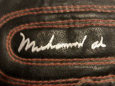 an old black baseball glove with the word mudman on it