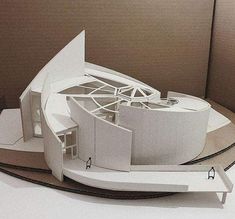 a model of a white building on top of a table