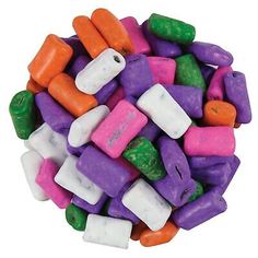 a pile of assorted colored candies on a white background