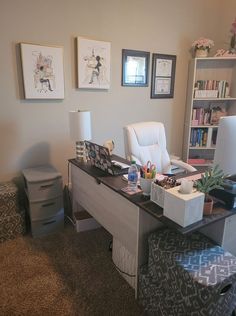 a desk with several items on it in the corner of a room, including a chair and bookshelf