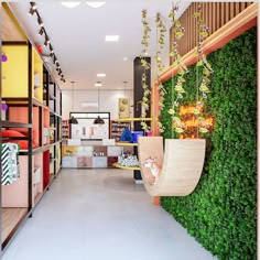 the interior of a retail store with plants growing on the walls and hanging from shelves