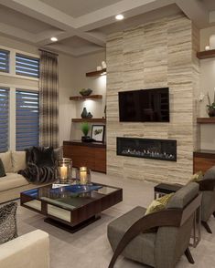 a living room filled with furniture and a flat screen tv mounted on the wall above a fireplace