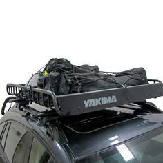 an suv with luggage strapped to it's roof rack on the back of it