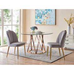 a glass table with two black chairs in front of it and a white rug on the floor