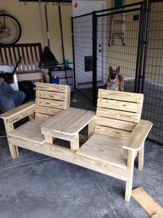 two wooden chairs sitting next to each other in a room with a dog on the floor